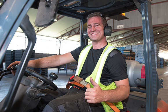 plain pallets employee riding forklift